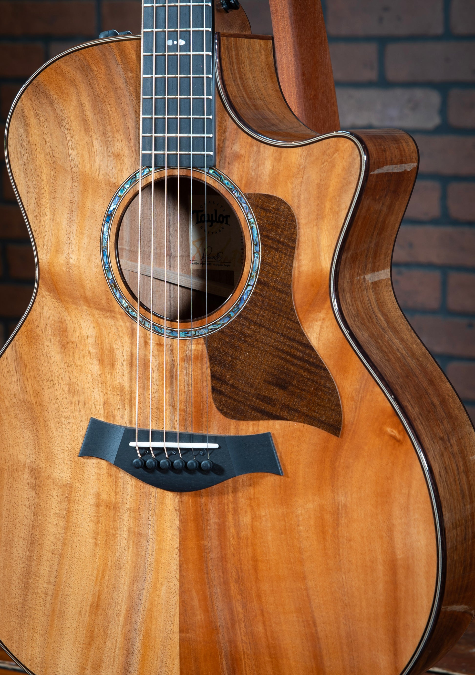 Acoustic Taylor 724ce Hawaiian Koa Guitar with rosewood binding, paua shell rosette, and dark-stain pickguard